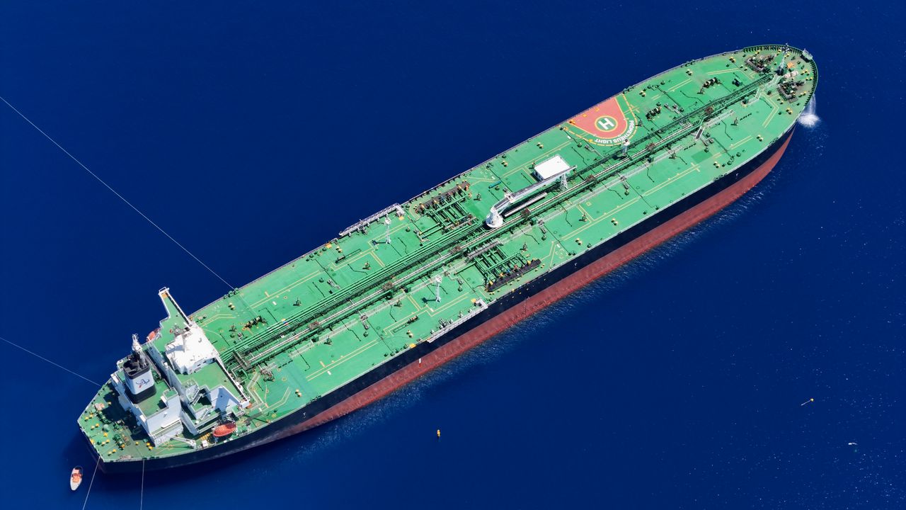 Mastering the First Impression: Your intriguing post title goes here Aerial shot of an oil tanker sailing in the ocean near Vado Ligure, Italy.