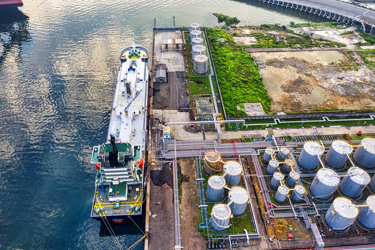 The Art of Drawing Readers In: Your attractive post title goes here Aerial view of a ship docking at an industrial port with storage tanks in North Jakarta.